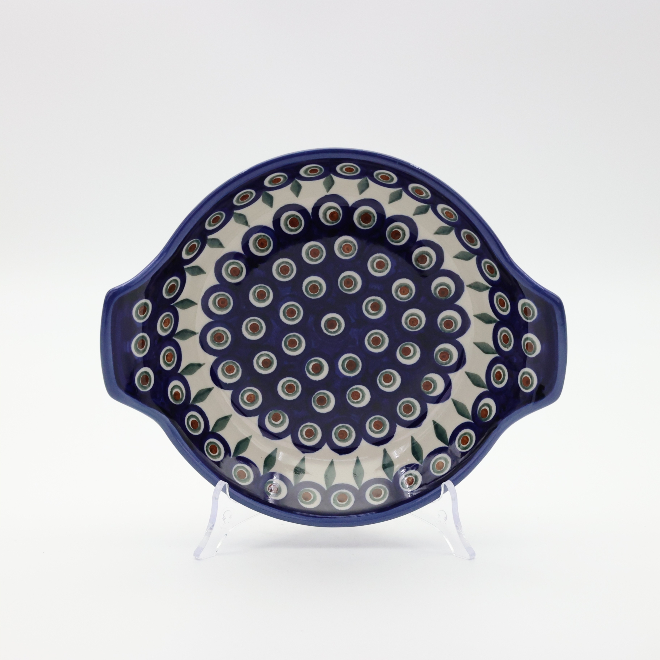 Round baking dish with handles made of Boleslawiec pottery.